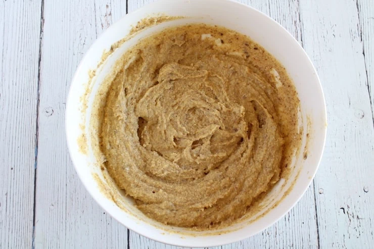 uncooked keto bread recipe dough in white bowl on white wooden table