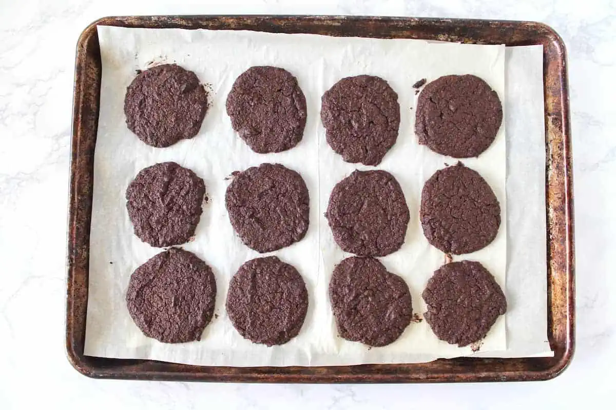 Finished chocolate cookies on a baking sheet lined with parchment paper