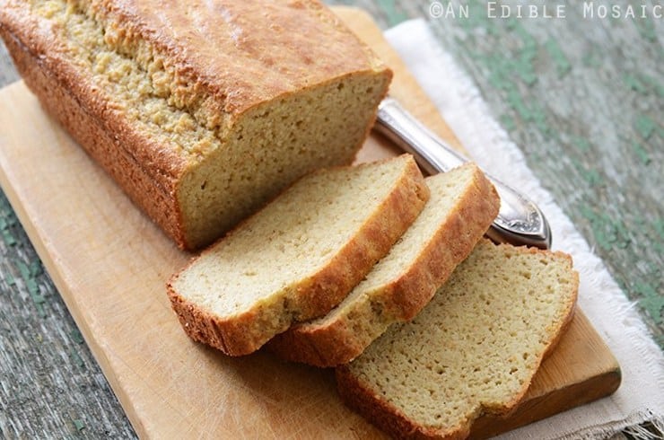 closeup of paleo sandwich bread with four slices out of the loaf on a cutting board