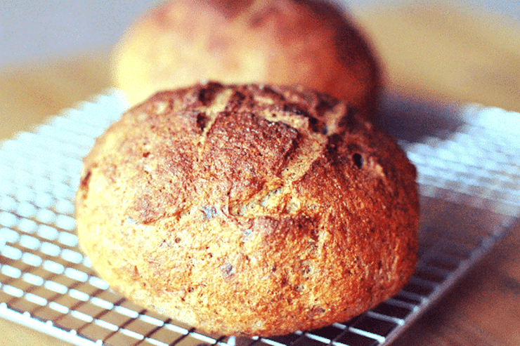 close up of rustic grain free bread round on a wire rack