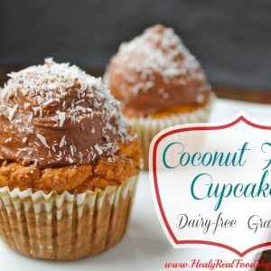 coconut flour cupcakes sitting on a white plate and topped with coconut