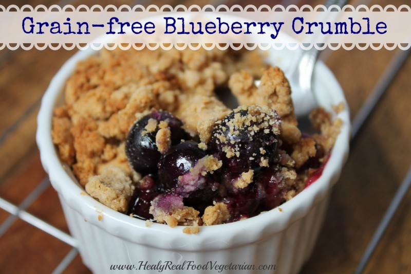 A close up of grain-free blueberry crumble in a white ramekin