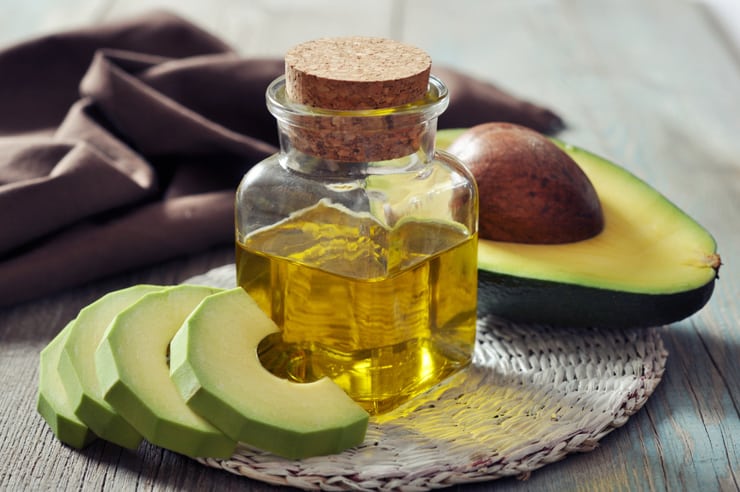 bottle of avocado oil and avocados