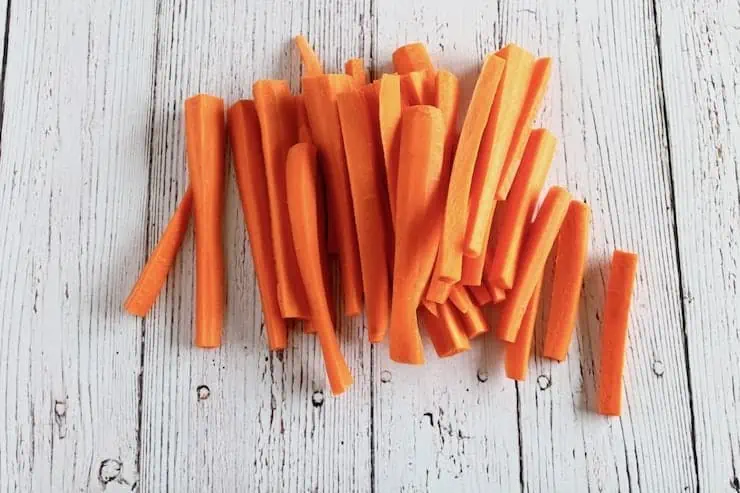 Sliced carrots on a white wooden table