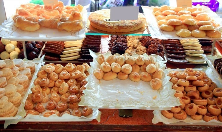 A photo of cakes in a window of a bakery