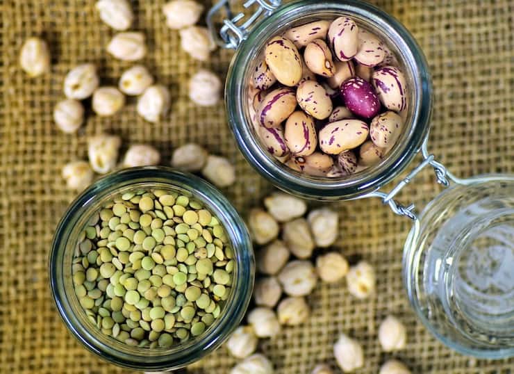 Jars of legumes on a burlap mat