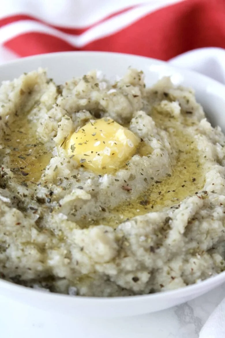 A bowl of cauliflower puree with butter on top.