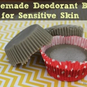grey deodorant bars in muffin liner cups on a yellow and white striped surface