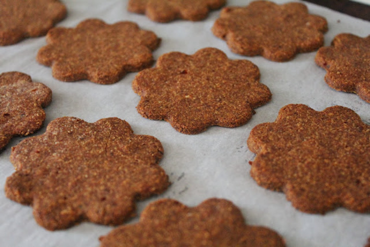 A close up of thin ginger cookers cut in the shape of flowers