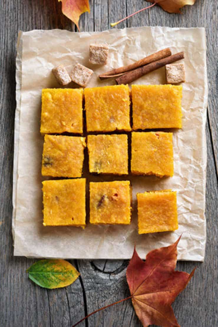 Pumpkin fudge squares sitting on brown paper