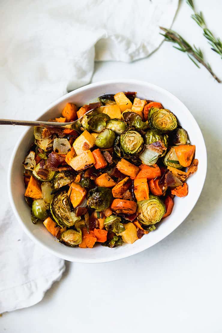 An overhead shot of roasted sprouts and vegetables in a bowl