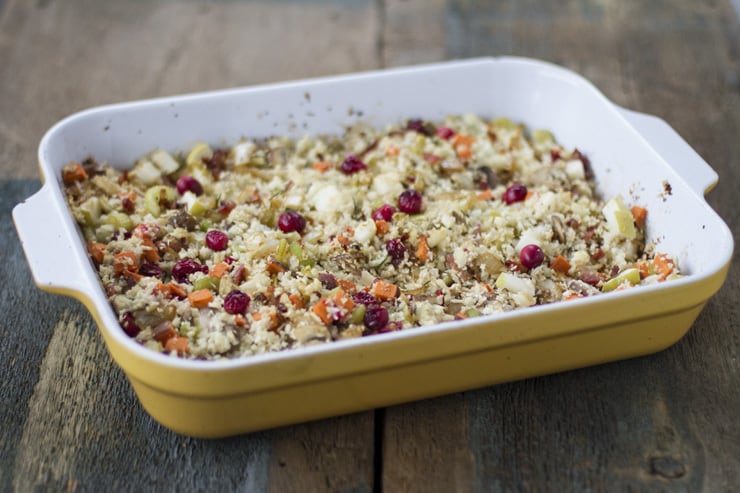 A large tray of stuffing on a wooden surface