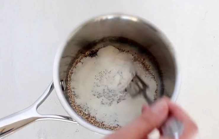 Dry no oats oatmeal ingredients in a stainless steel pot on a white wooden table