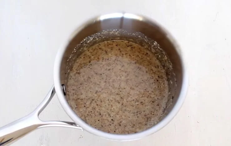 All no oats oatmeal ingredients in a stainless steel pot on a white wooden table