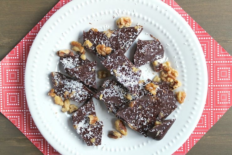 Chocolate bark broken into pieces on a white plate