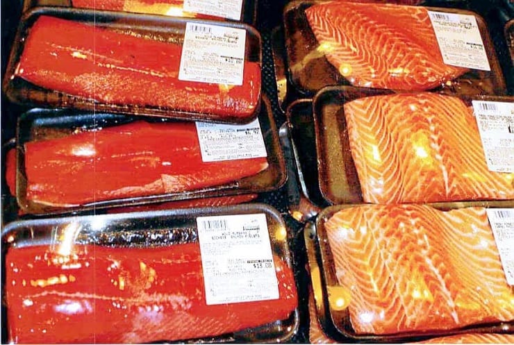 A photo of packaged wild salmon and farmed salmon in a supermarket