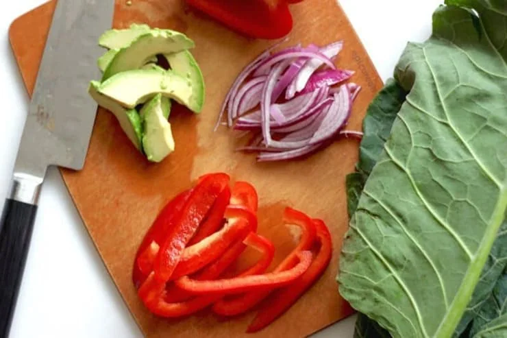 Healthy breakfast burrito ingredients on a wooden surface