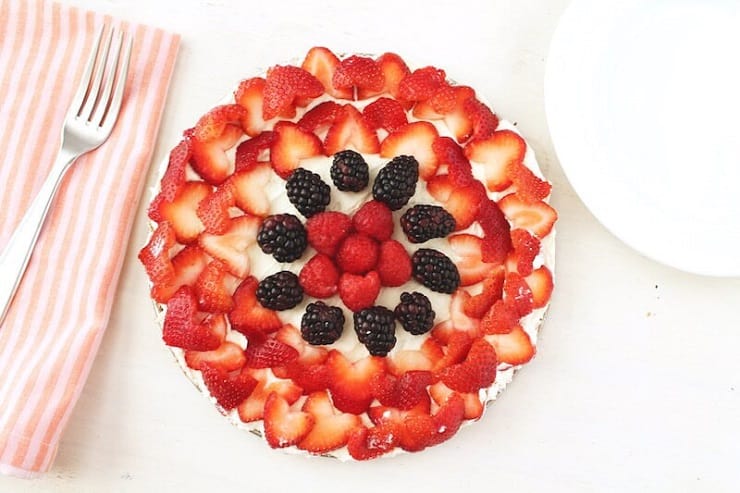 An overhead shot of a No Bake Fruit Tart made with red berries and a fork at the side