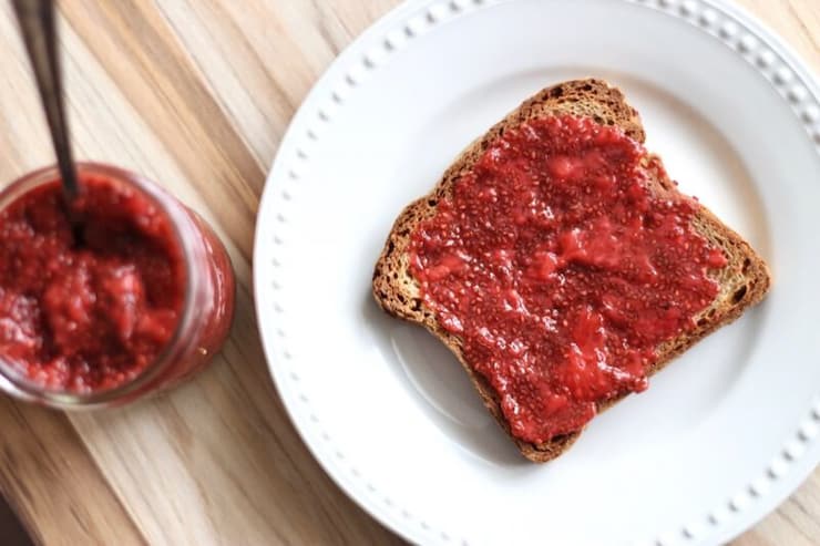 A slice of toast with chia strawberry jam spread on top