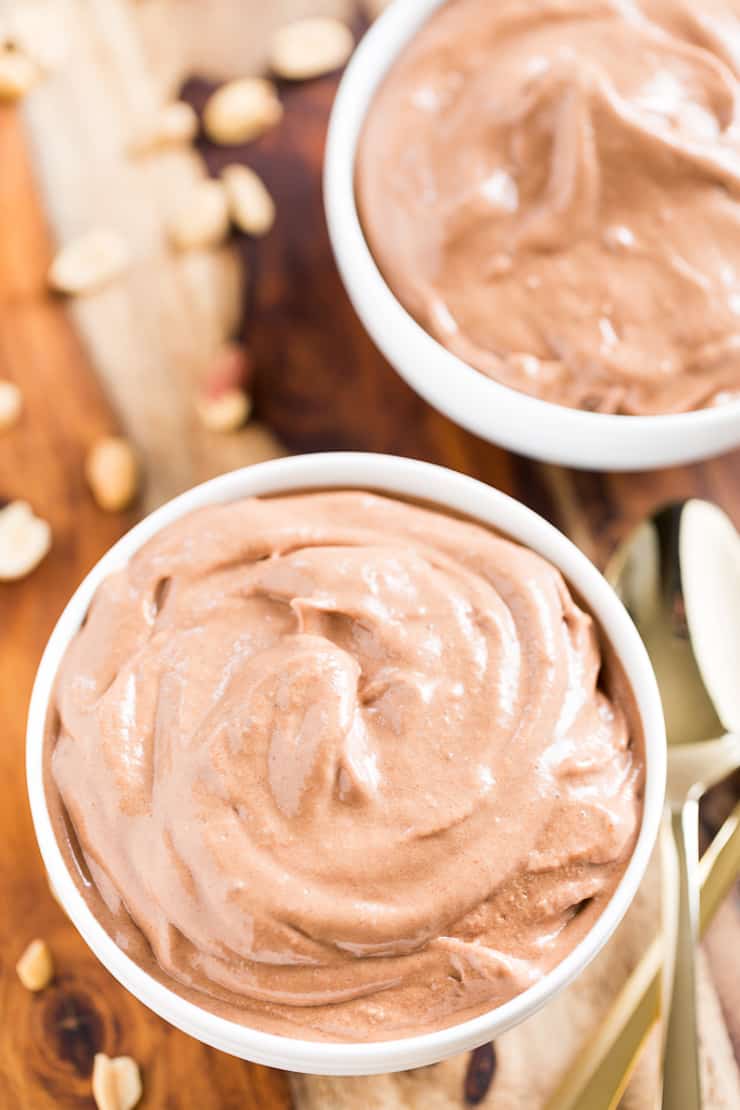 two white bowls filled with brown chocolate ice cream