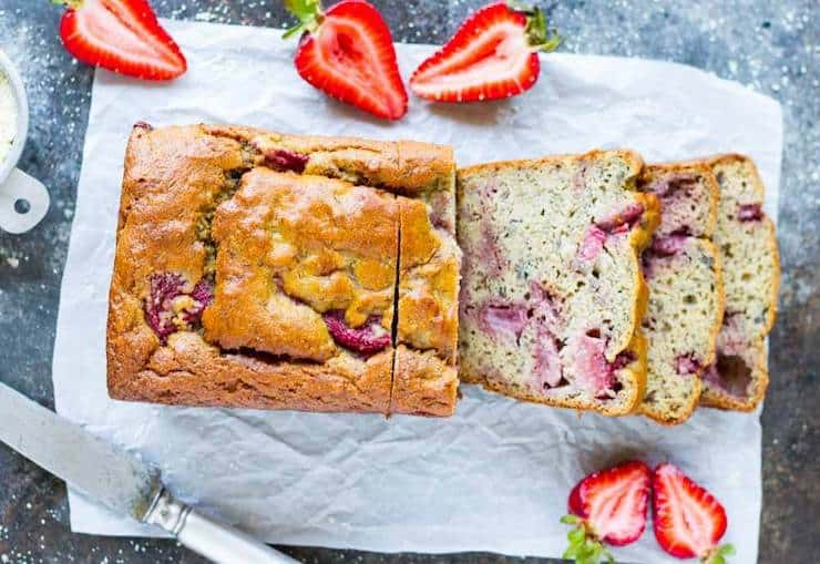 overhead view of whole loaf of strawberry bread with four slices out of it