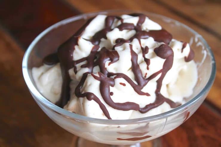 Banana ice cream in a bowl drizzled with chocolate