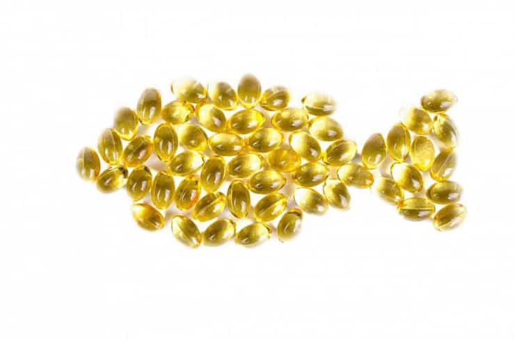 Yellow gel capsules arranged in the shape of a fish
