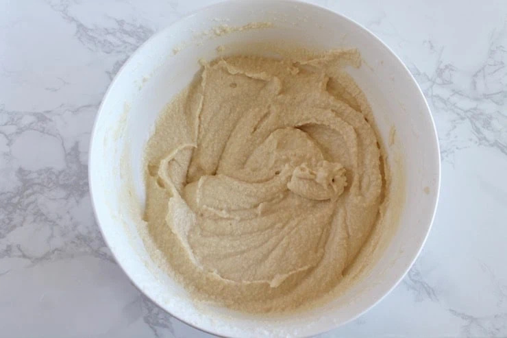 Paleo biscuit batter in white bowl on marble counter