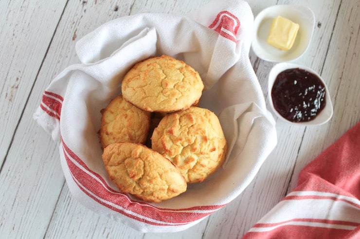 Dish towel lined bowl filled with yellow paleo biscuits