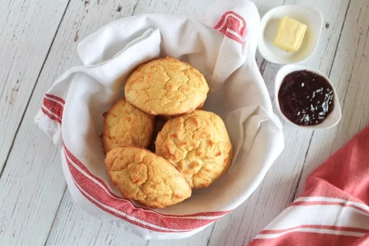 Dish towel lined bowl filled with yellow paleo biscuits