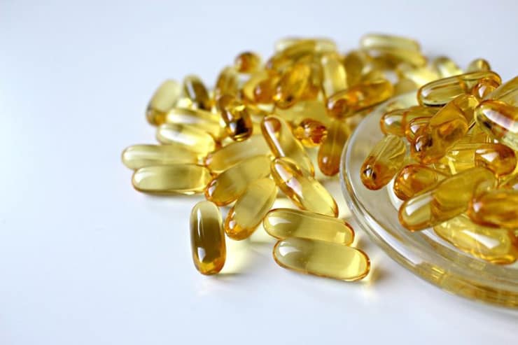 Yellow gel capsules in a pile