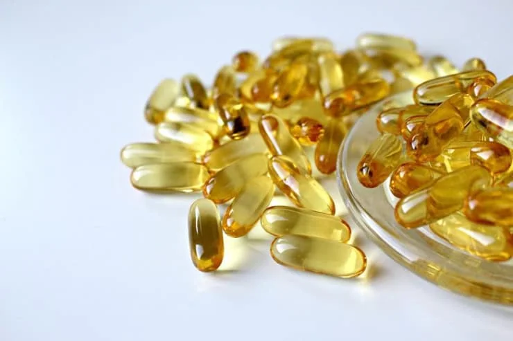 Yellow gel capsules in a pile