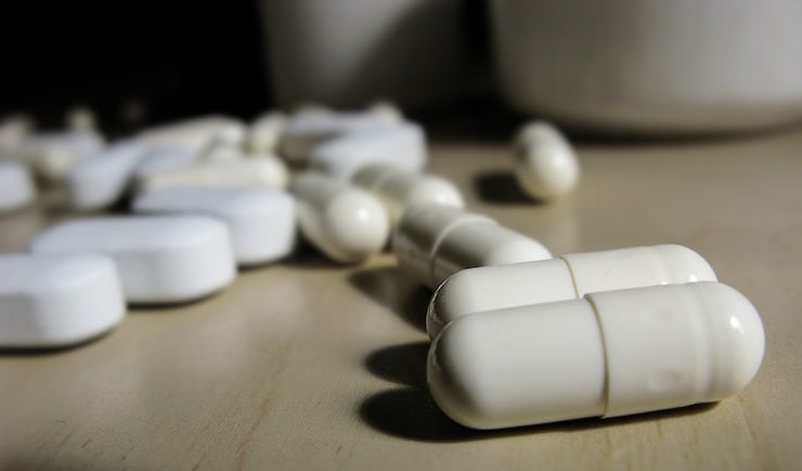 white vitamin capsules on a table