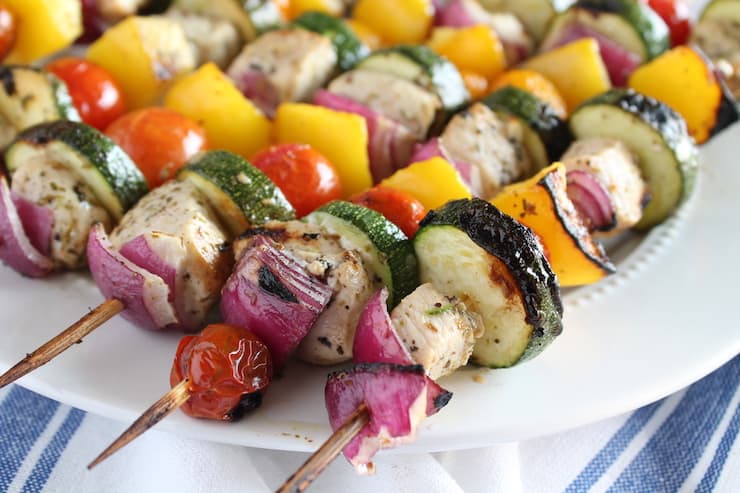 Close up of chicken kabob with veggies and chicken on wooden skewer