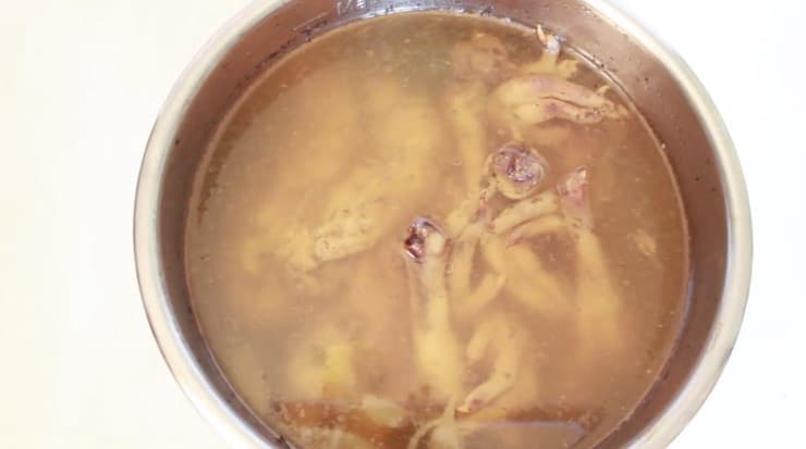 Pot with chicken bones and broth in it