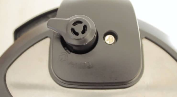 Pressure cooker lid vent set to sealed position