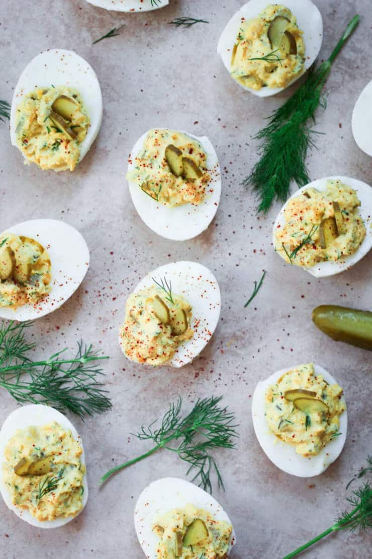 Pickled devilled eggs on a blue work surface