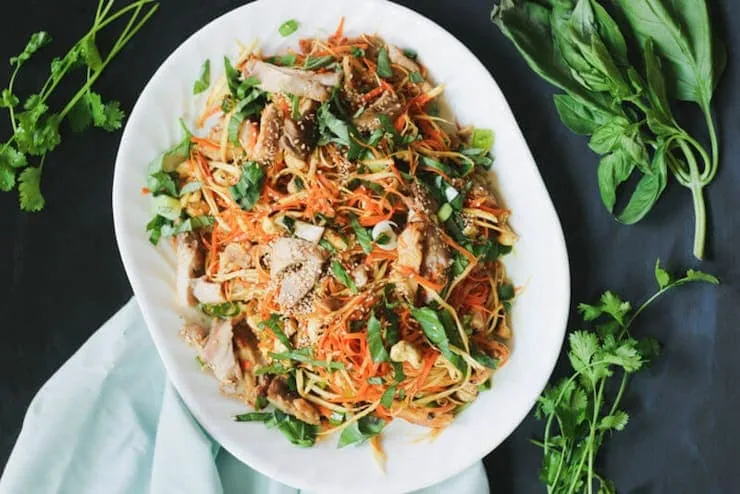 A chicken noodle salad on a large serving plate
