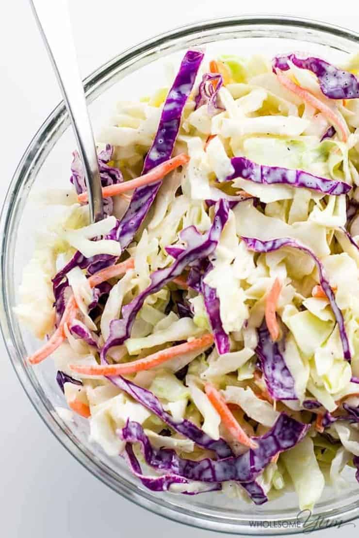 An overhead shot of coleslaw in a glass bowl