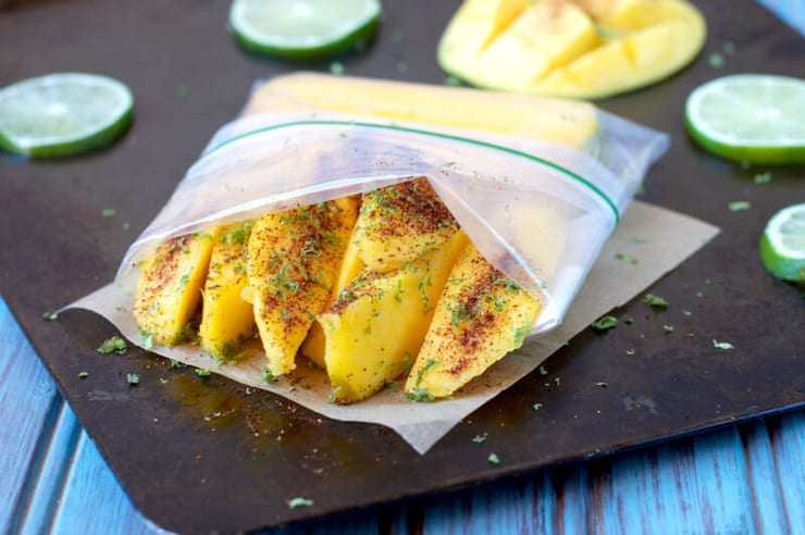 Slices of mango on a black surface