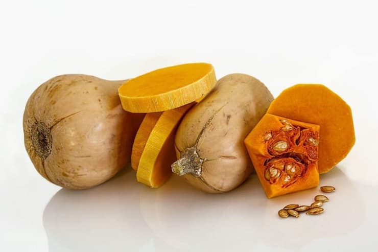 Slices of butternut squash on a white surface