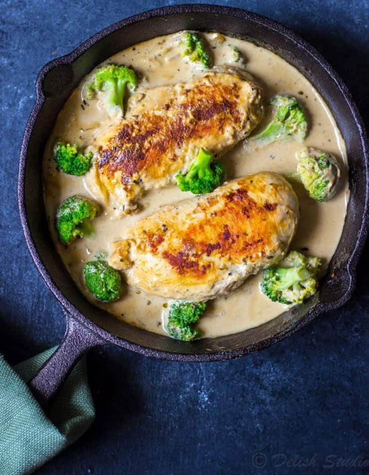 Chicken with a cream sauce and broccoli in a skillet