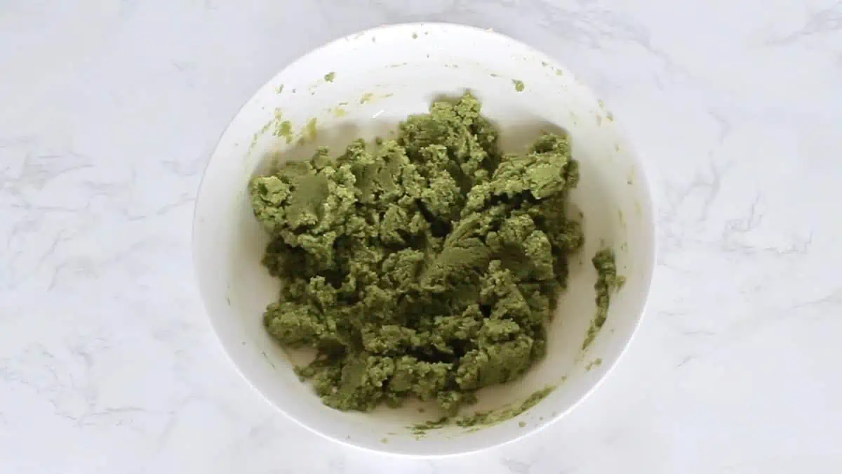Green matcha cookie dough in a white bowl
