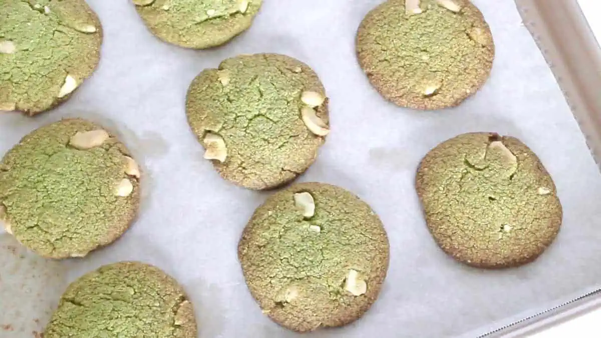 Baked matcha green tea cookies on a baking sheet lined with parchment paper