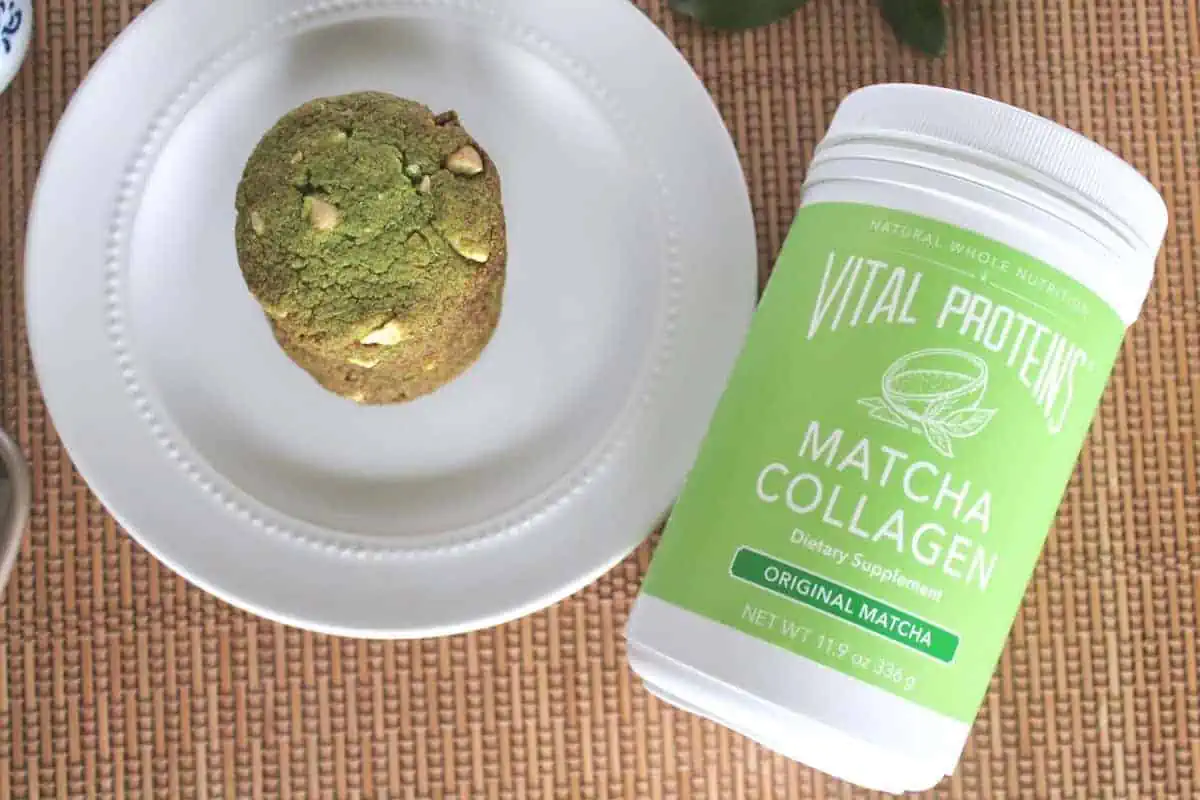 Matcha cookies on a white plate with a tub of match collagen at the side