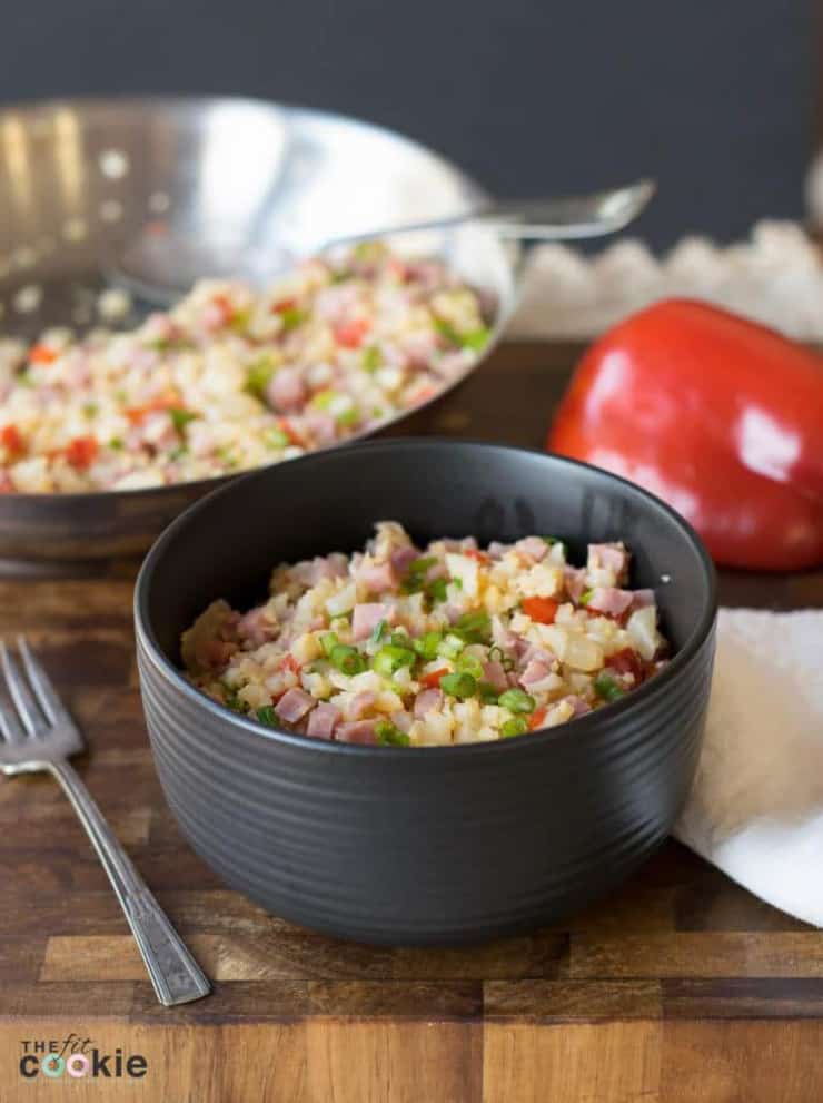 Pork fried rice in a small black bowl