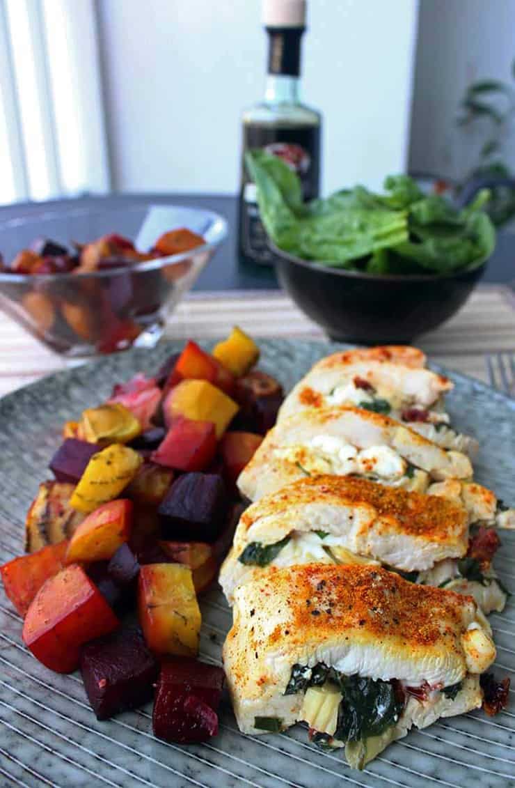 Stiffed chicken breast cut into slices on a plate with vegetables