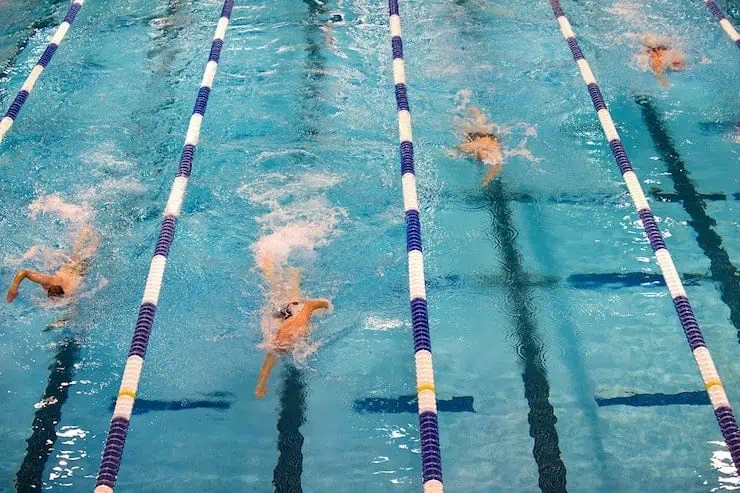 swimming pool lanes with people swimming laps