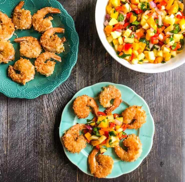 Coconut shrimp on a blue plate with salsa