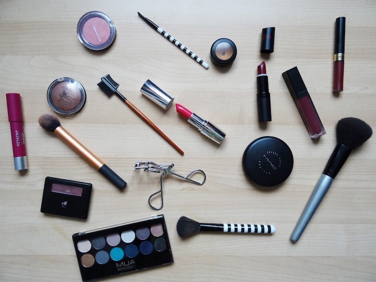 Various array of makeup products laid out on a table
